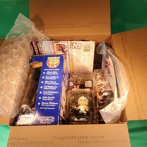 Priority box filled with sports memorabilia, mixed action figures, baseball, Etc